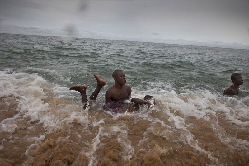 © Fernando Moleres - Abdul Sesay teaching swimming to his friend Michael. Both live in Saint Michael center and go to the same class.