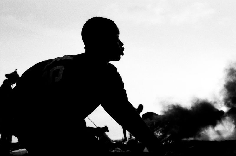 © carolina rapezzi - Accra. Agbogbloshie. A group of workers in the "Kilimanjaro" burning area burning wires and appliances.