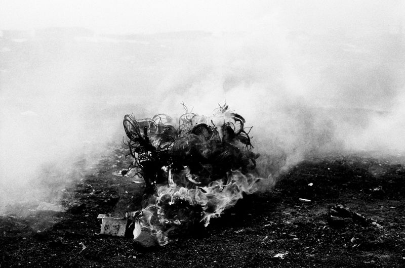 © carolina rapezzi - Accra, Agbogbloshie. A tangle of cables and wires taken out of different appliances burning in the "Kilimanjaro" area.