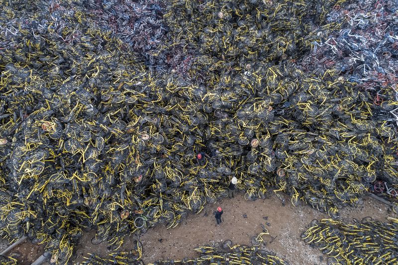 © WU GUOYONG - 04 Xiamen, China The 200,000 shared bicycles cleared by the government are piled up here, just like a hill. 2018/04/14/