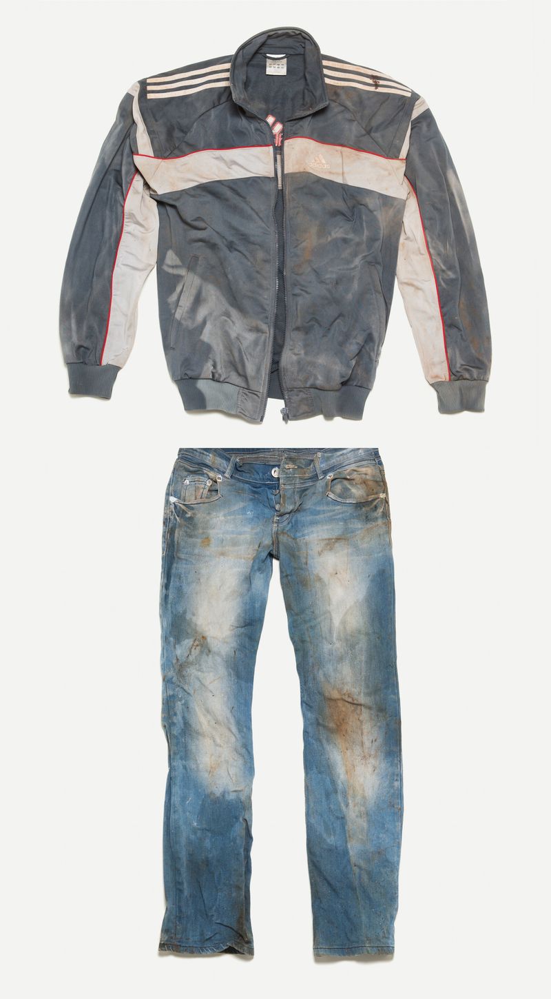 © Gianni Cipriano - Tracksuit jacket and jeans left on a vessel that carried refugees across the Mediterranean Sea.  Sicily, 2015