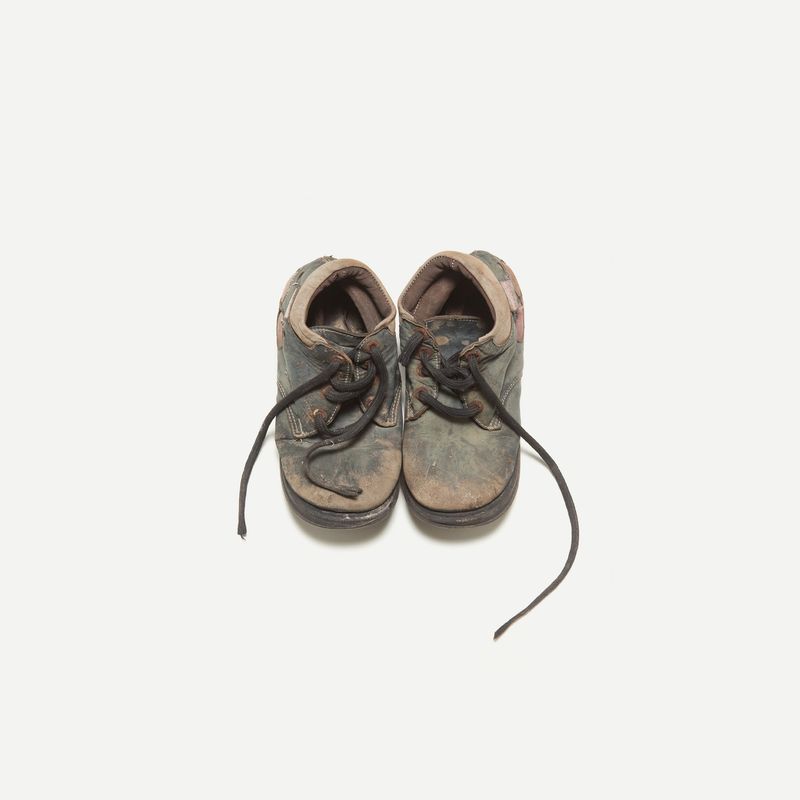 © Gianni Cipriano - Children shoes left on a vessel that carried refugees across the Mediterranean Sea.  Sicily, 2015 