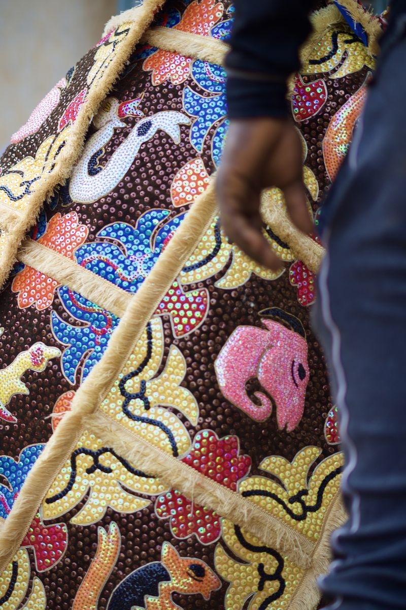 © Paola Chapdelaine - Detail of a revenant habit, made of complex and colorful embroideries.