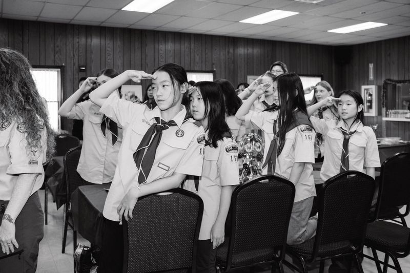 © Paola Chapdelaine - Girls from Troop 163 make a scout salute during the ceremony celebrating the first female Eagle Scouts of Closter.