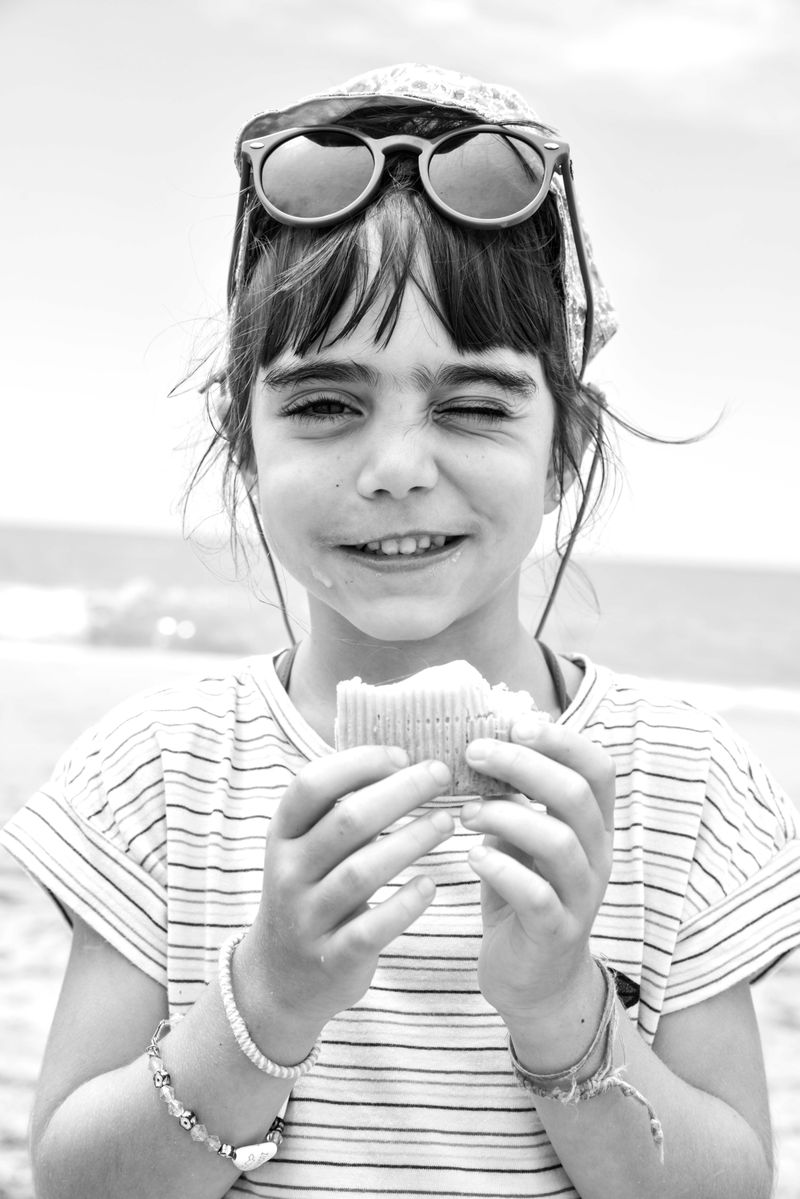 © Madelaine Ekserciyan - Summer holidays at the beach. The most desired ice-cream of the day, triple flavour. strawberry, vanilla and chocolate.