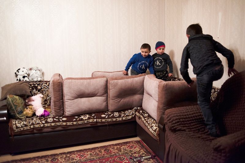 © Madelaine Ekserciyan - Two brothers playing with their older cousin to built a house and protecting it from falling apart.