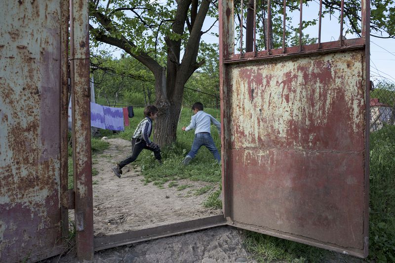 © Madelaine Ekserciyan - Two brothers playing in their home backyard.