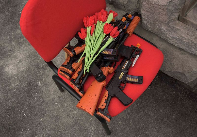 © Madelaine Ekserciyan - Toy guns and paper flowers waiting in the chair before the kindergarten show starts.