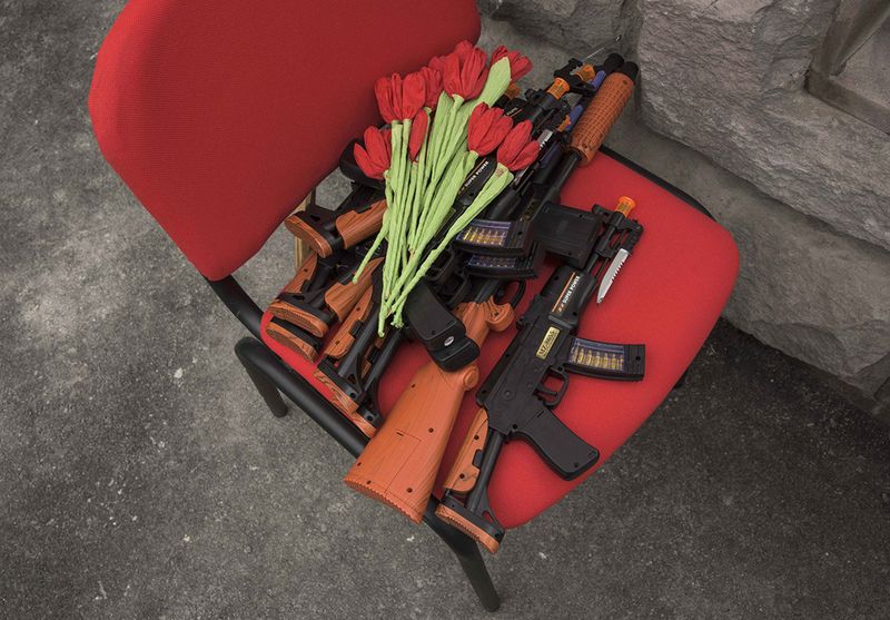 © Madelaine Ekserciyan - Toy guns and paper flowers waiting in the chair before the kindergarten show starts.