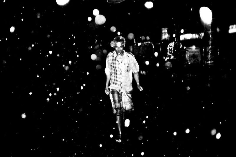 © K. M. Asad - Rain comes in the street.