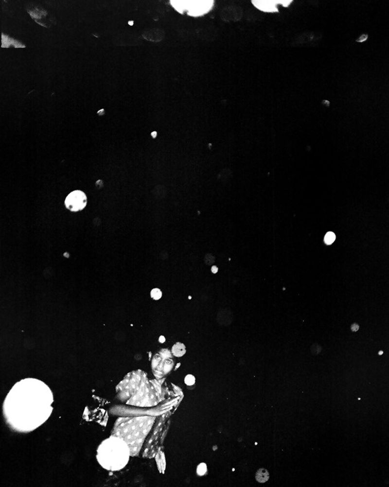 © K. M. Asad - A boy run when rain come in the street.