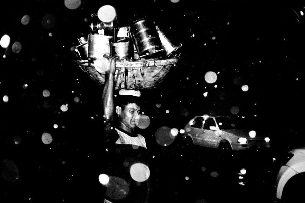 © K. M. Asad - Day labour doing his own work in to the heavy rain.