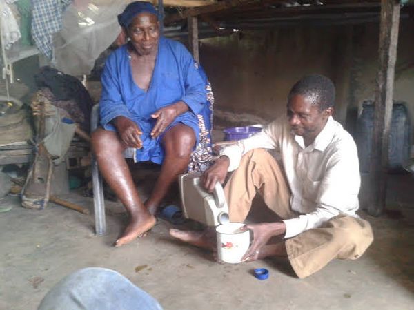 © Christopher FON ACHOBANG - Chief Bibi (130 years) is served by great-grand son in Taraba State Nigeria