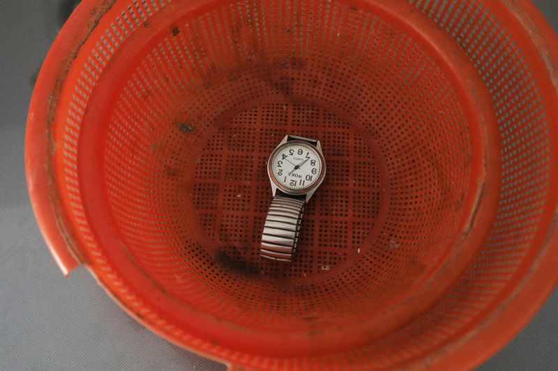 © Zifan Zhang - Yu Zhangfu’s broken watch in a basket at home.