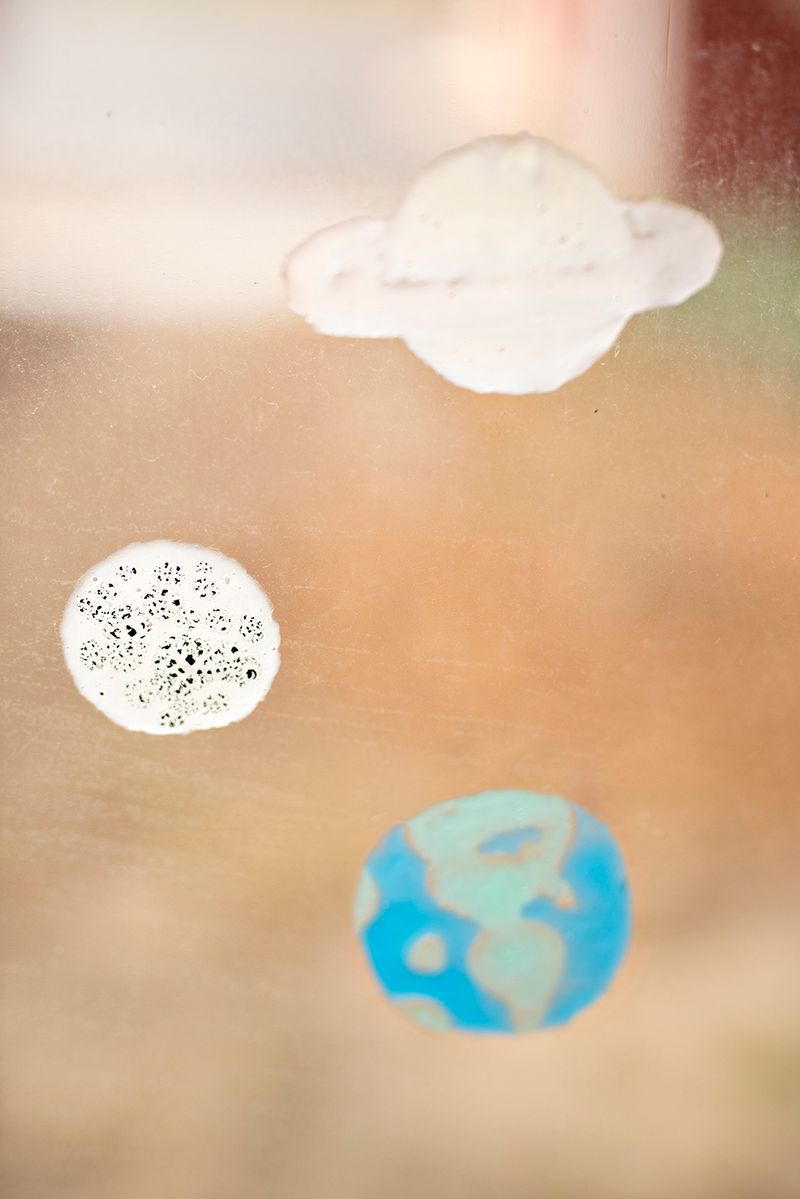 © Danielle Ezzo - Hand-Painted Planets on My Bedroom Window, 2024