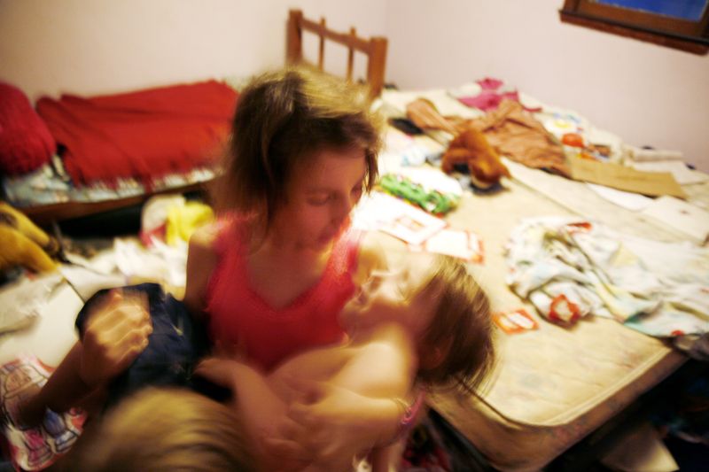 © Uno  Yi - Regina cradles David. Regina's diary said, "I'm proud of being a big sister of four."