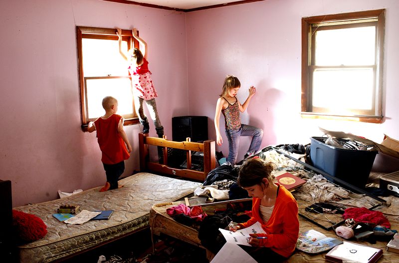 © Uno  Yi - David, Abby and Piper play while Regina does homework.