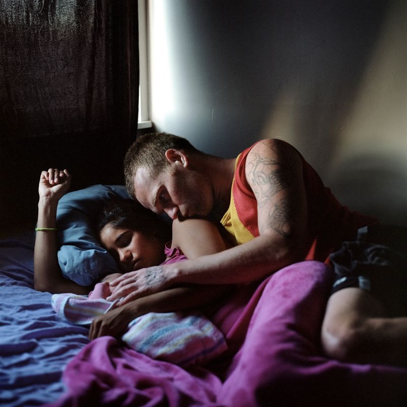 © Raphaela Rosella - Shiralee's other sister Tricia lays with her partner Troy and their three-day-old baby girl Ty-Leta.