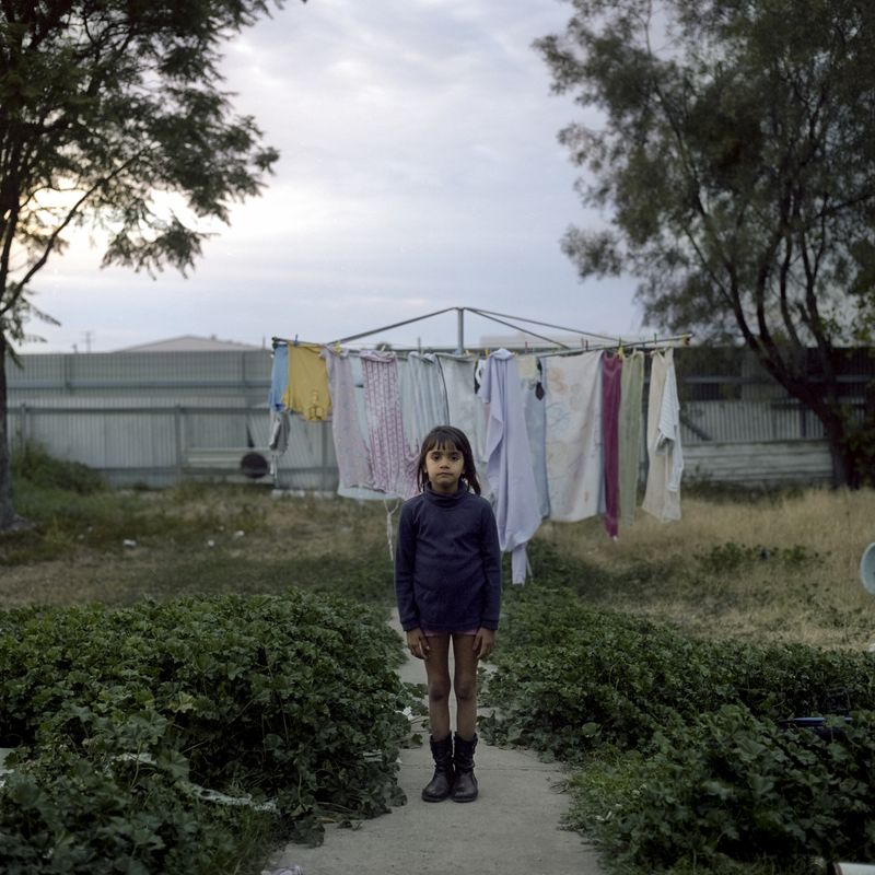 © Raphaela Rosella - Laurinda stands in her back yard.