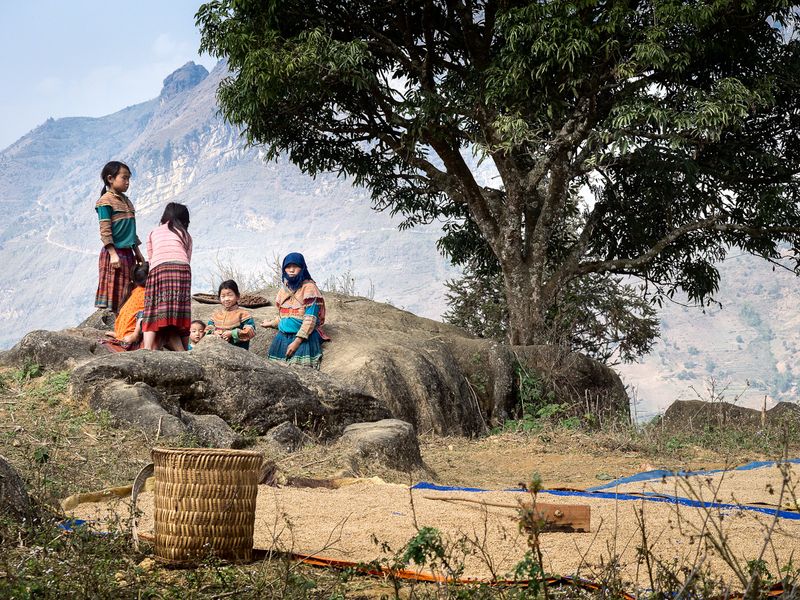 © Tony Corocher - "Living in harmony with nature" - Woman with children looking after the harvest near a village at the border with China.