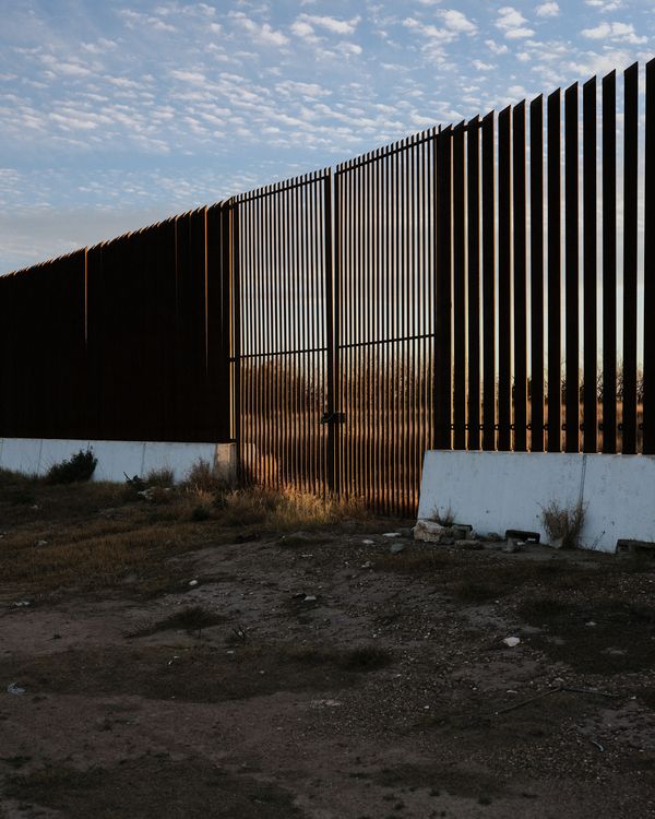 © Jordan Conway - A gate on the US / Mexico border wall locked shut during sunset.