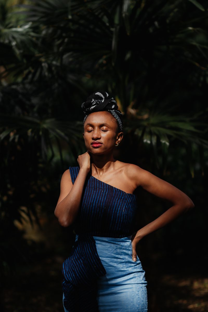 © Philippa James - Gambian Sun in Oxford. Dressed in her traditional Gambian outfit, Amienatou soaks up the sun in a local Oxfordshire park.