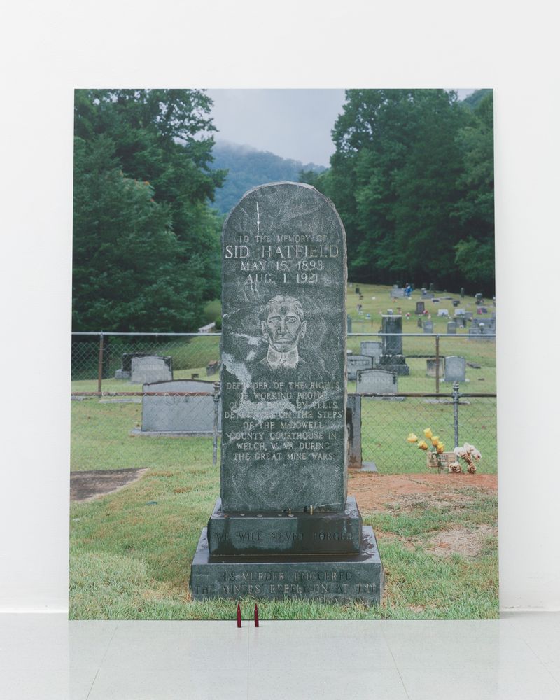 © Ian Byers-Gamber - Smilin' Sid's Tombstone (With Offerings), UV print on dibond, .556 snap caps, 2024