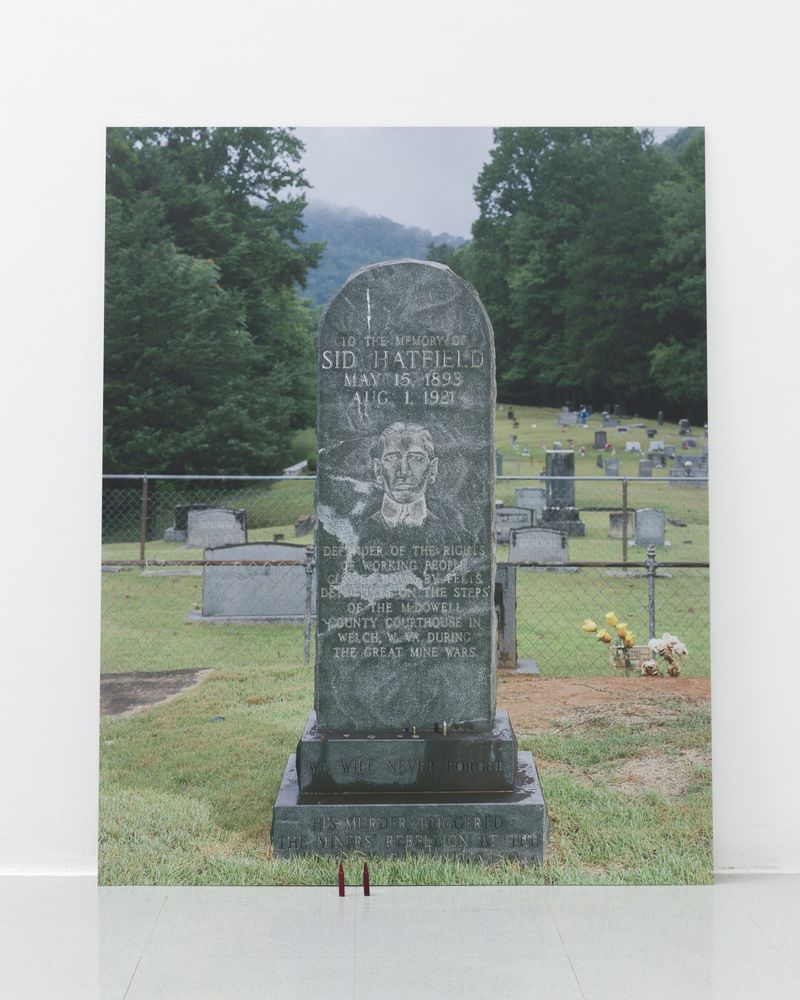 © Ian Byers-Gamber - Smilin' Sid's Tombstone (With Offerings), UV print on dibond, .556 snap caps, 2024