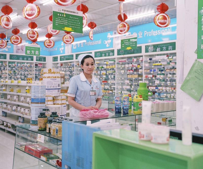 © Patrick Wack - May 2016. Pharmacy clerk in a pharmacy in Kashgar.