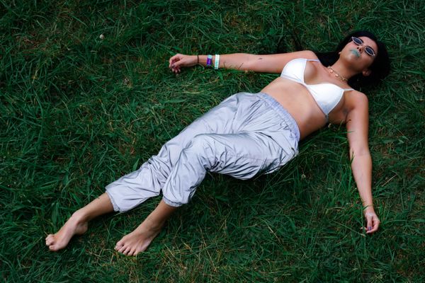 © Samantha Morse - Aubrie lies in the lush grass of the campground.