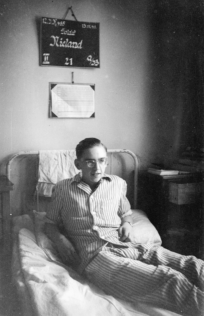 © Stefan Nieland - Image of Heinz Nieland laying in his bed inside the military hospital in Königgrätz. From my families archive, 1941.
