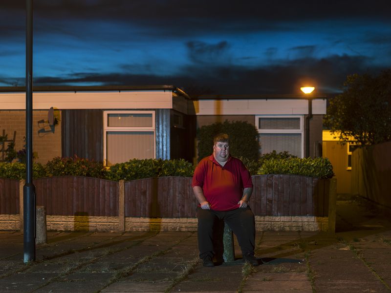 © Polly Braden - Kenny sitting near his house