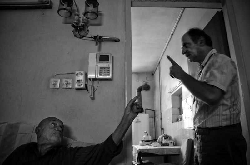 © Khashayar Sharifaee - His son MohammadReza is arguing with him and telling him, “don’t eat so much sweats! It’s harmful for you”