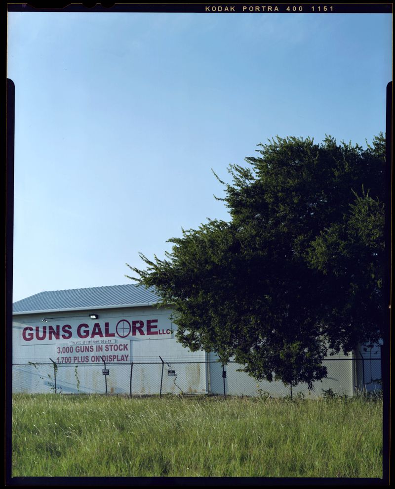 © Christian K. Lee - Gun store advertisement.