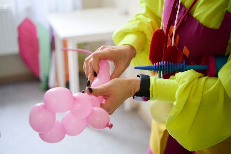 © Aleksandra Konoplyeva - Isabella is making a toy from a baloon