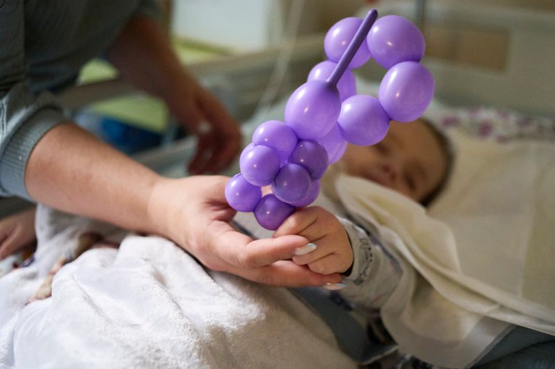 © Aleksandra Konoplyeva - patient's hand with a toy