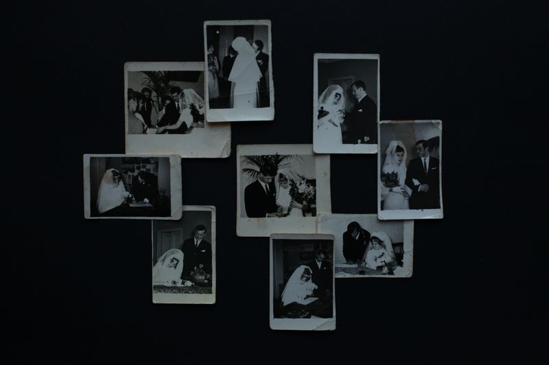 © Arina Titova - These are tiny old photos attached to the red book. In the photos one can see grandmother's friends getting married.