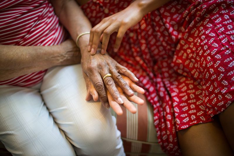 © Lindsay Morris - The hands of Maymette and her great-granddaughter, Emma.