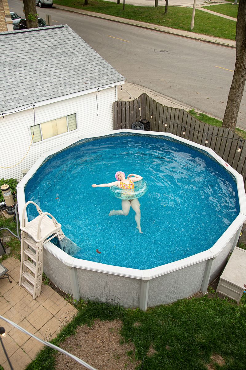 © Lindsay Morris - Ryan, a former Camp I Am camper, cools off in her urban backyard pool.