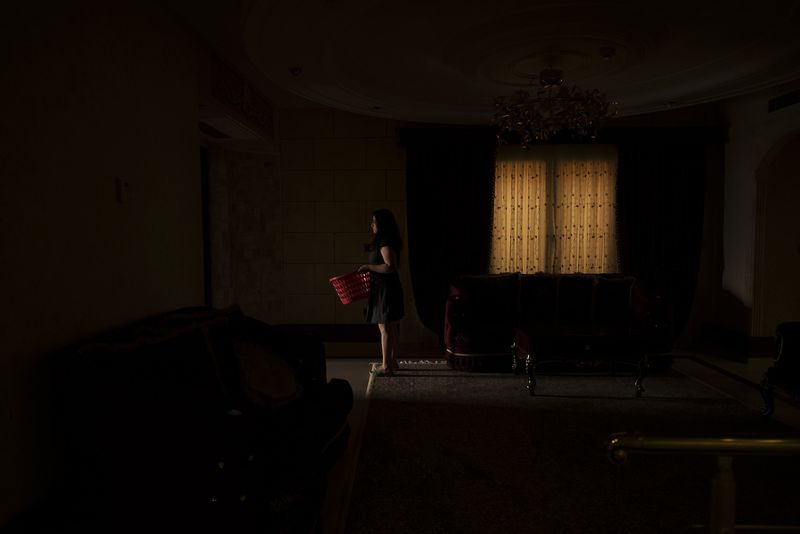 © Marjan Yazdi - Afsaneh, 30, housewife. Afsaneh is holding a basket with the washed clothing in it.
