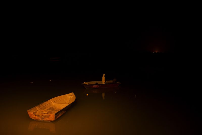 © Marjan Yazdi - A fisherman going to the sea very late night for fishing.
