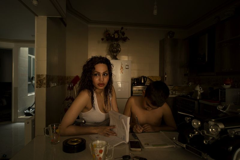 © Marjan Yazdi - Naghmeh , 37, hair stylist. Naghmeh is helping her son in his homework.