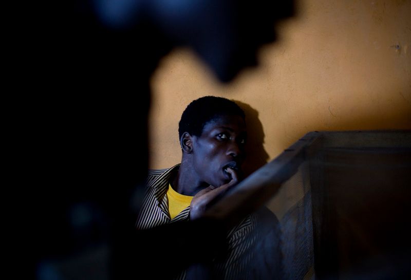 © Anne Ackermann - Young boys are watching TV in a public place.