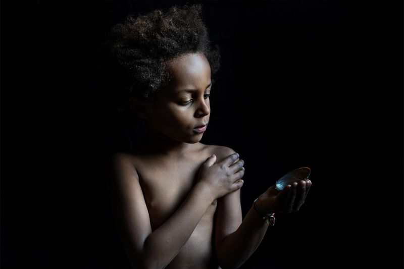 © Anne Ackermann - Portrait of my son Luis with a river shell. 2020.