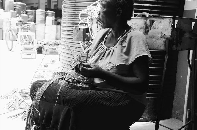 © Rhonda Welch - Widow weaving mats to sell