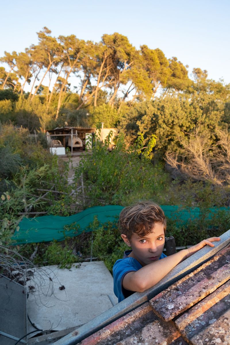 © Daniel Rolider - Kerem, a family friend, climbs on our house's rooftop in Shikun Ella neighborhood, Kiryat Tivon, Israel, October 2016.