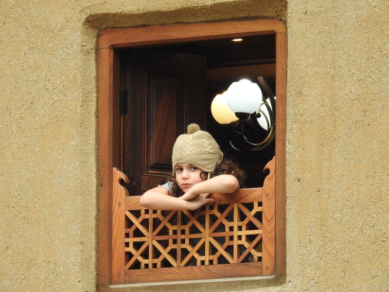 © Morteza Beiglou - The girl who tries to wait and gaze the future of life in the historical home in middle of the old window.