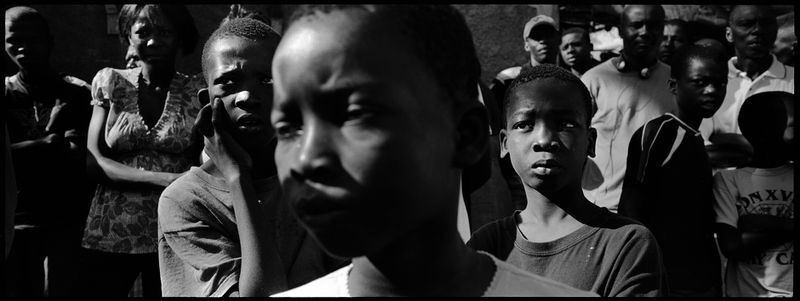 © Benjamin Rusnak - Beleaguered and aimless, earthquake survivors wander through a tent camp in Port-au-Prince a week after the earthquake.