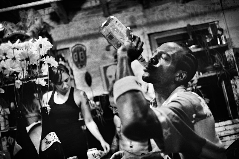 © Julie Glassberg - Tess drinking liquor during a night at the Chicken Hut.
