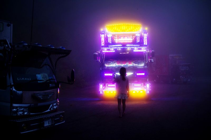 © Julie Glassberg - A girl standing in front of Ryujin Maru. Sendai Prefecture, in a foggy mountain area close to the city of Fukushima.